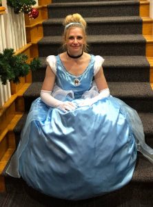 Woman in Cinderella gown sitting on a staircase