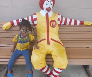 little boy on bench with ronald mcdonald