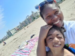 woman and son smiling for photo on the beach