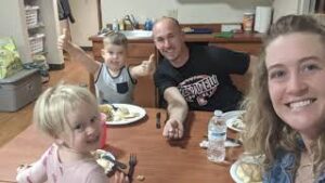 Brown family sitting around table.