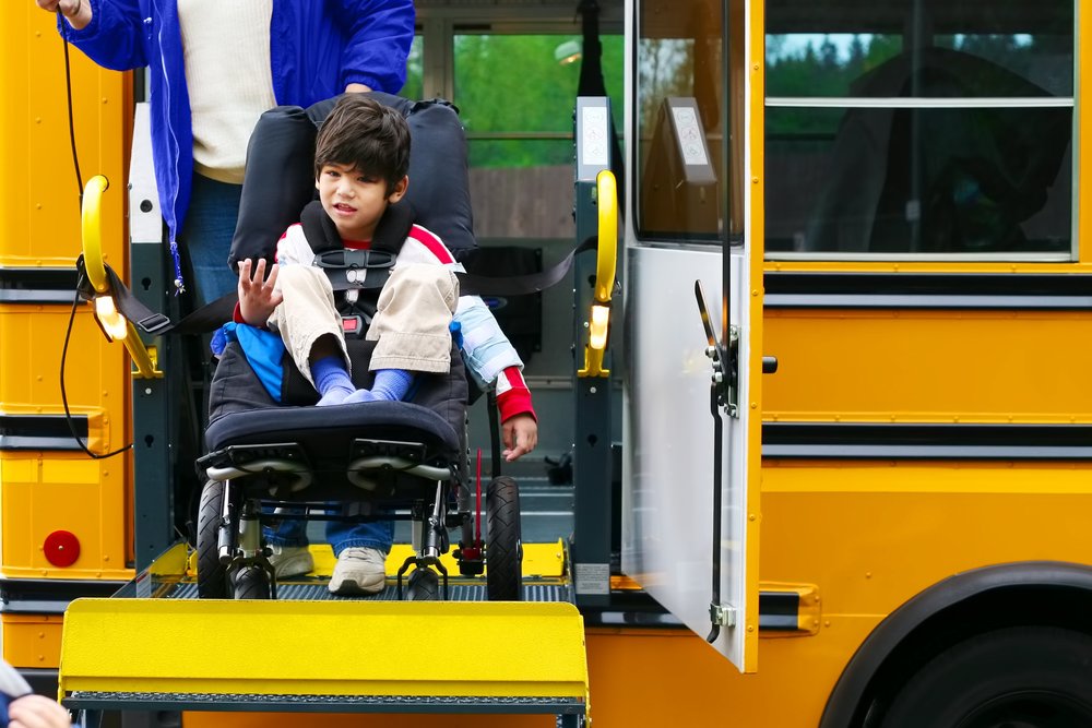 Child in wheelchair boarding school bus