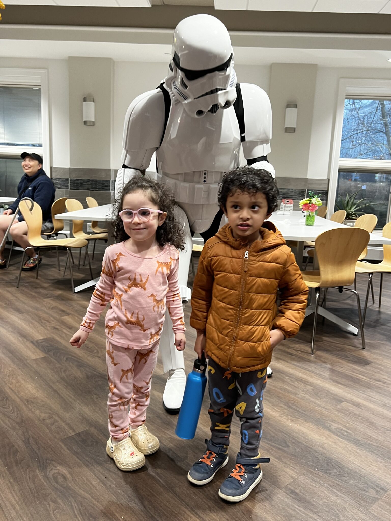 little boy and girl posing with star wars storm trooper character.