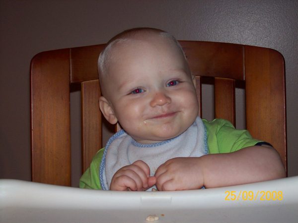 Baby Carter Nedley smiling in a chair