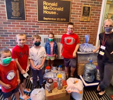 children with pull tab collection in atrium