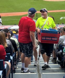 Joe Kleinhenz serving snacks and drinks